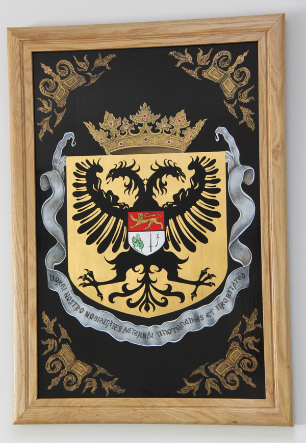 A painted memorial board carrying the family arms